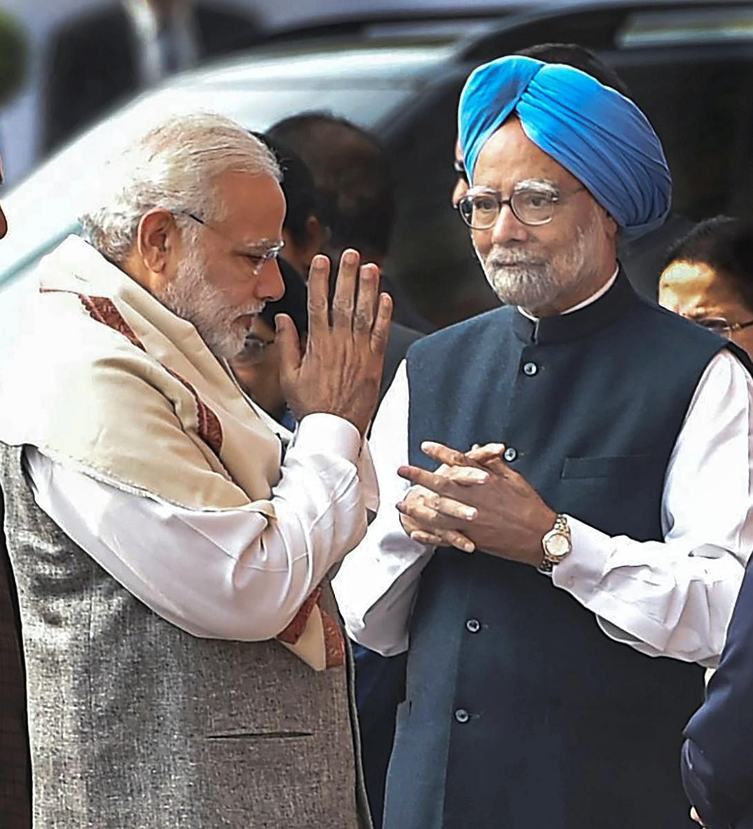 New Delhi: Prime Minister Narendra Modi and former prime minister Manmohan Singh exchange greetings during the tribute paying ceremony for the martyrs of 2001 Parliament attack on its 16th anniversary, at Parliament House in New Delhi on Wednesday. PTI Photo by Vijay Verma (PTI12_13_2017_000036B)