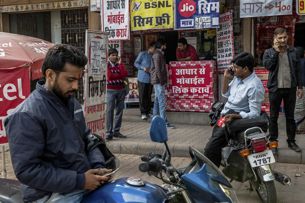 Mobile phones in use on the street in Jodhpur, India, Dec. 4, 2017. Google, which missed out on the rise of the internet in China, is determined not to make the same mistake in India. (Rebecca Conway/The New York Times)