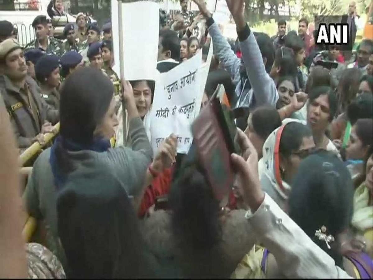 Members of the Congress' women wing raised slogans against the poll body and carried placards demanding action against the prime minister and other BJP leaders for allegedly violating the model code of conduct in Gujarat. Image: ANI Twitter