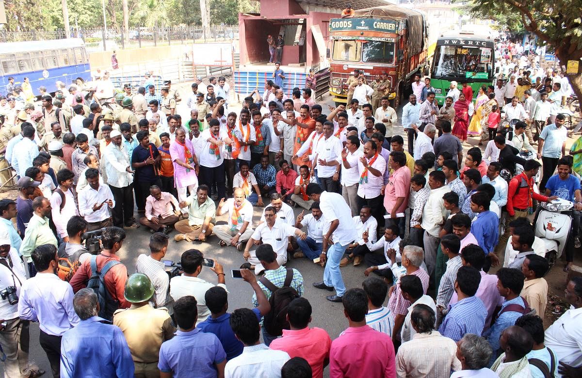 BJP workers and corporators block Lamington Road in front of the HDMC central office in Hubballi on Thursday.