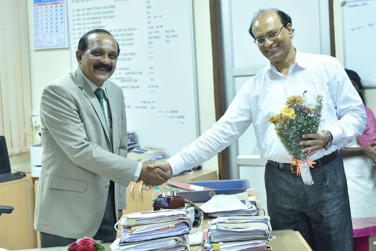 Prof B S Nagendra Prakash (left) took charge from Prof K M Lokesh as the new registrar of Mangalore University on Wednesday.