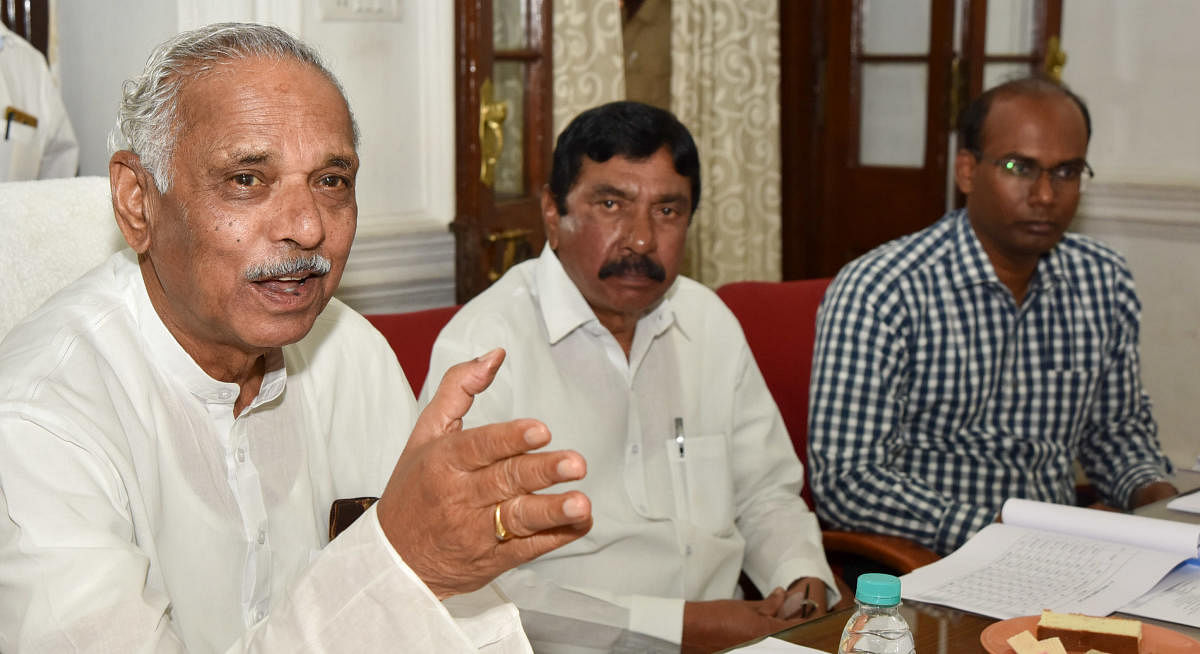 Revenue Minister Kagodu Thimmappa speaks during a review meeting of the district-level officials of the Revenue department, in Mysuru, on Thursday. MLA Kalale Keshavamurthy and DC D Randeep are seen. DH PHOTO