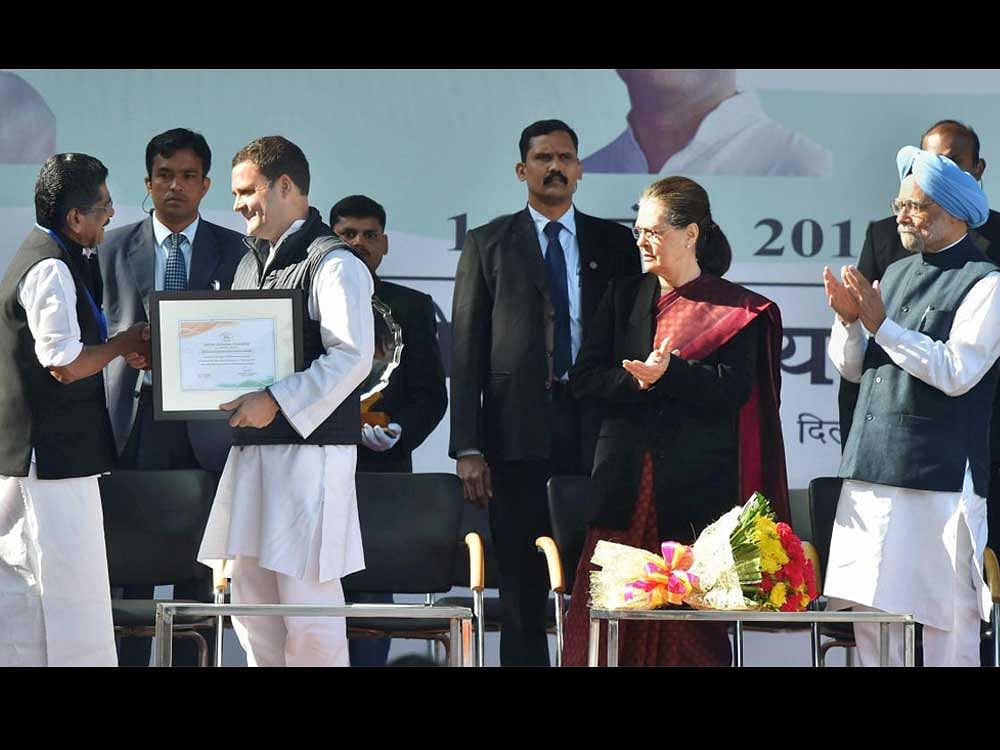 CEA chairman Mullappally Ramachandran hands over the certificate of party president to Rahul Gandhi during a grand event held at the lawns of the All India Congress Committee (AICC) in presence of his mother and predecessor Sonia Gandhi, and former prime minister Manmohan Singh, in New Delhi on Saturday. PTI Photo