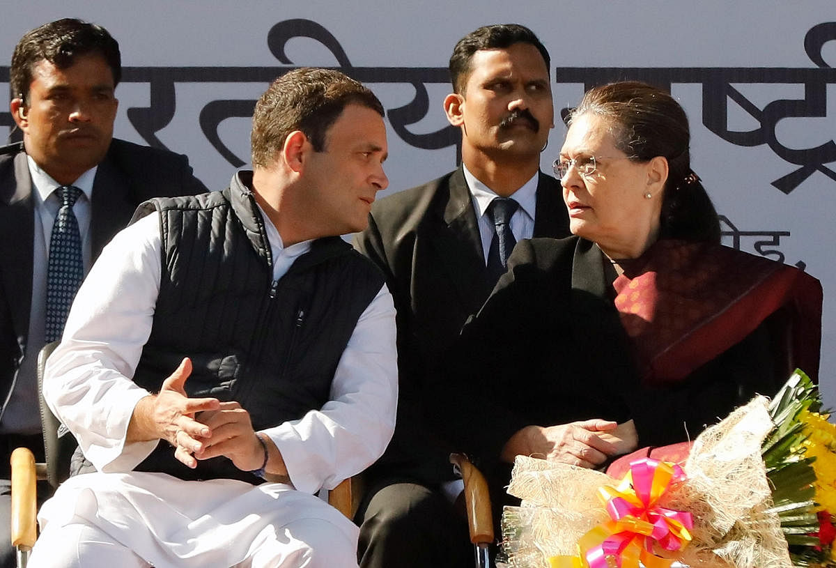Rahul Gandhi, the newly elected president of India's main opposition Congress party, speaks with his mother and leader of the party Sonia Gandhi after taking charge as the president during a ceremony at the party's headquarters in New Delhi. PTI file photo