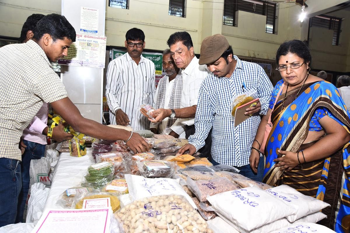 Visitors look at millets and other products at the Organic & Millets Mela at Laxmi Sadan at JC Nagar in Hubballi.