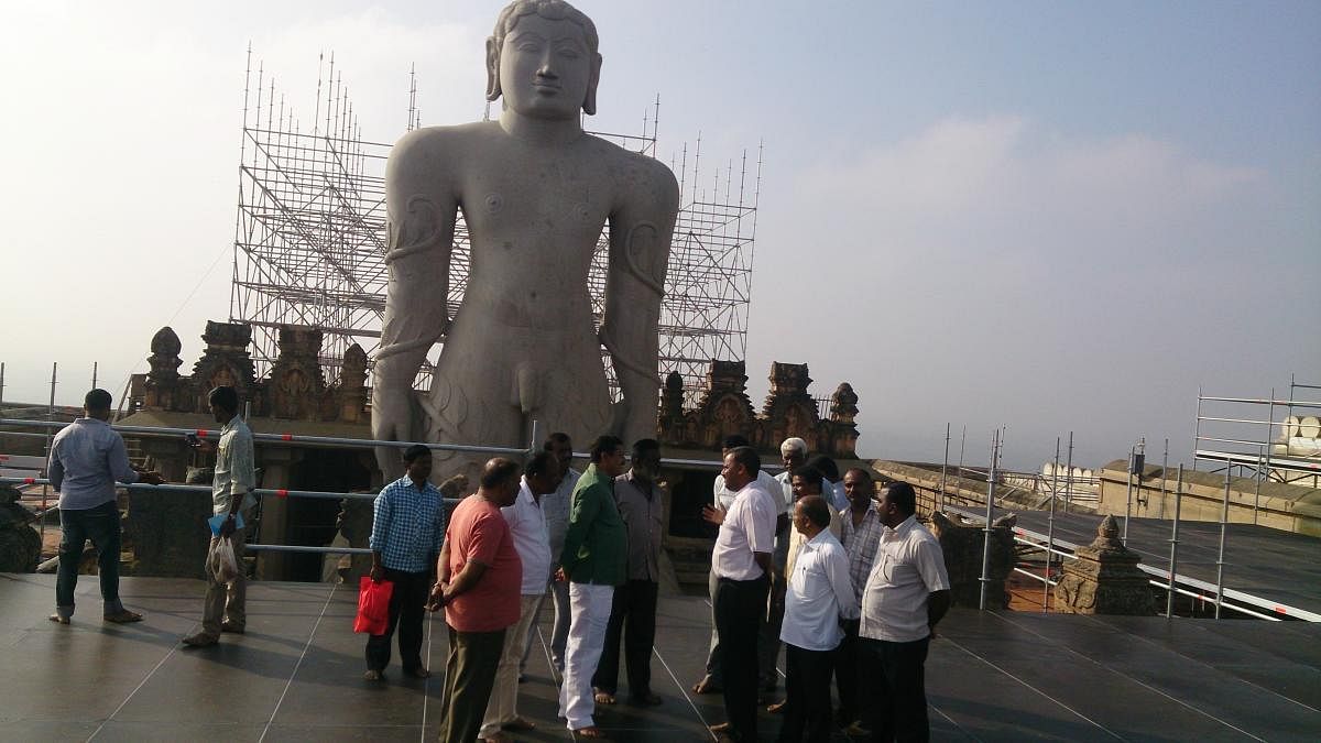 Gopalaswamy inspects the ongoing works of the attic behind the monolithic statue of Bahubali at Vindhyagiri in Shravanabelagola on Saturday.