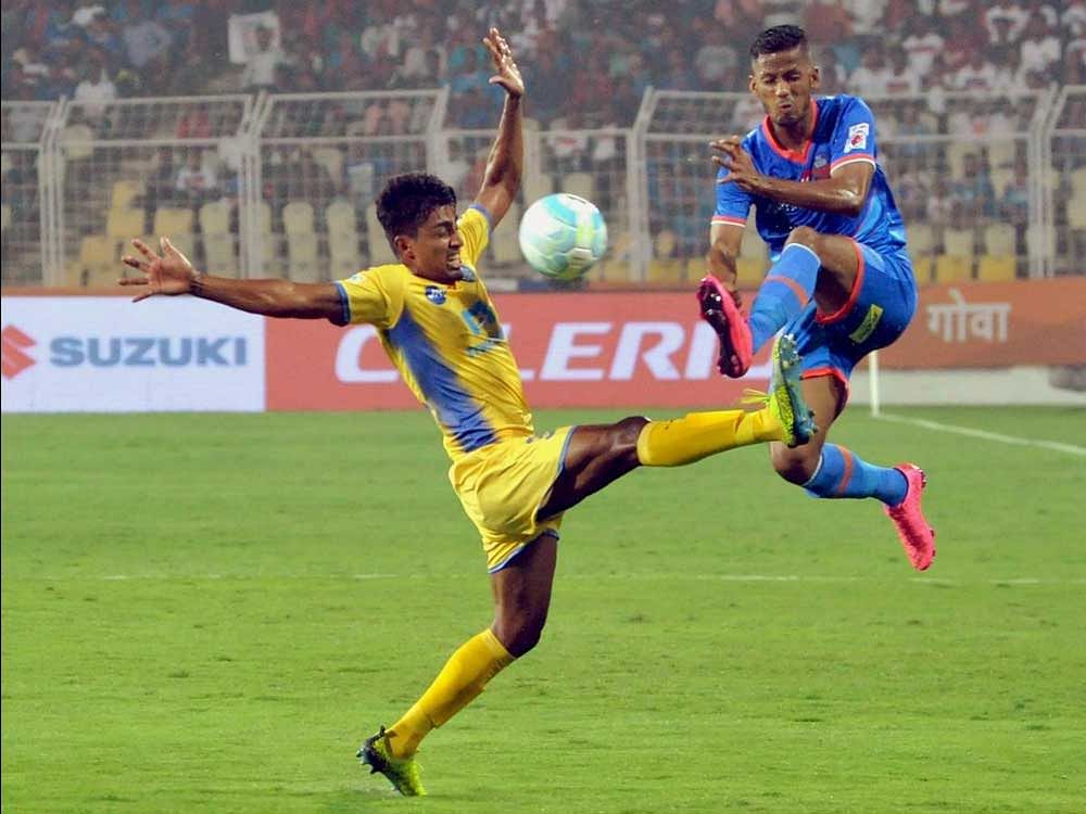 Kerala FC and FC Goa players vie for the ball during ISL match at JLN stadium in Fatorda on Saturday. FC Goa won the match by 5-2. PTI Photo