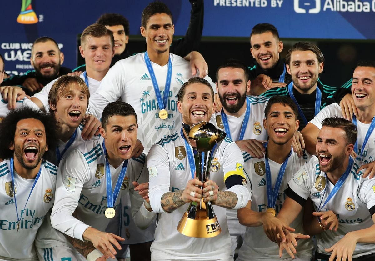 HIGH FIVE Real Madrid's players celebrate with the FIFA Club World Cup trophy in Abu Dhabi on Saturday. AFP