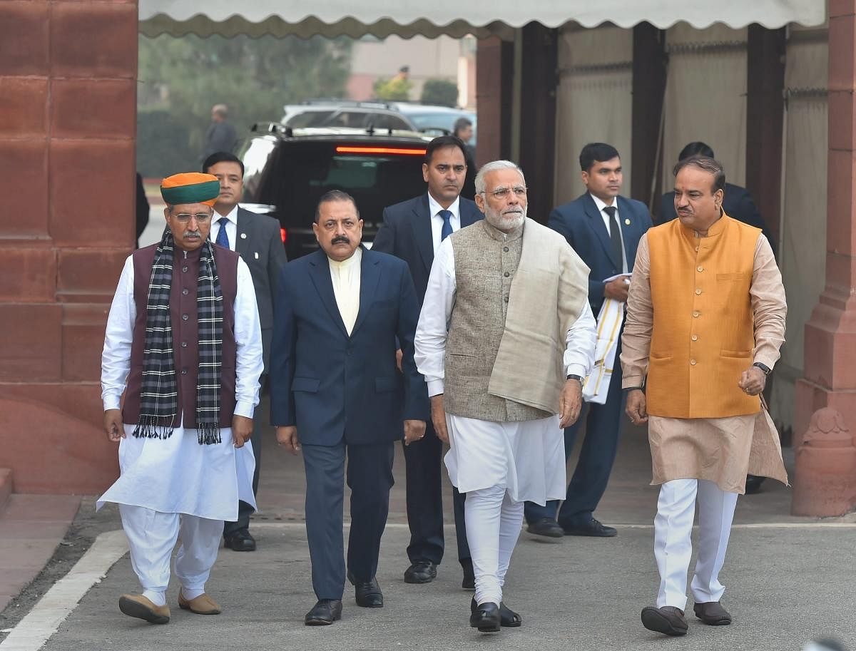Prime Minister Narendra Modi, flanked by Parliamentary Affairs Minister Ananth Kumar, Ministers of State Jitendra Singh and Arjun Ram Meghwal, arrives to address the media, on the first day of the winter session of Parliament. PTI Photo