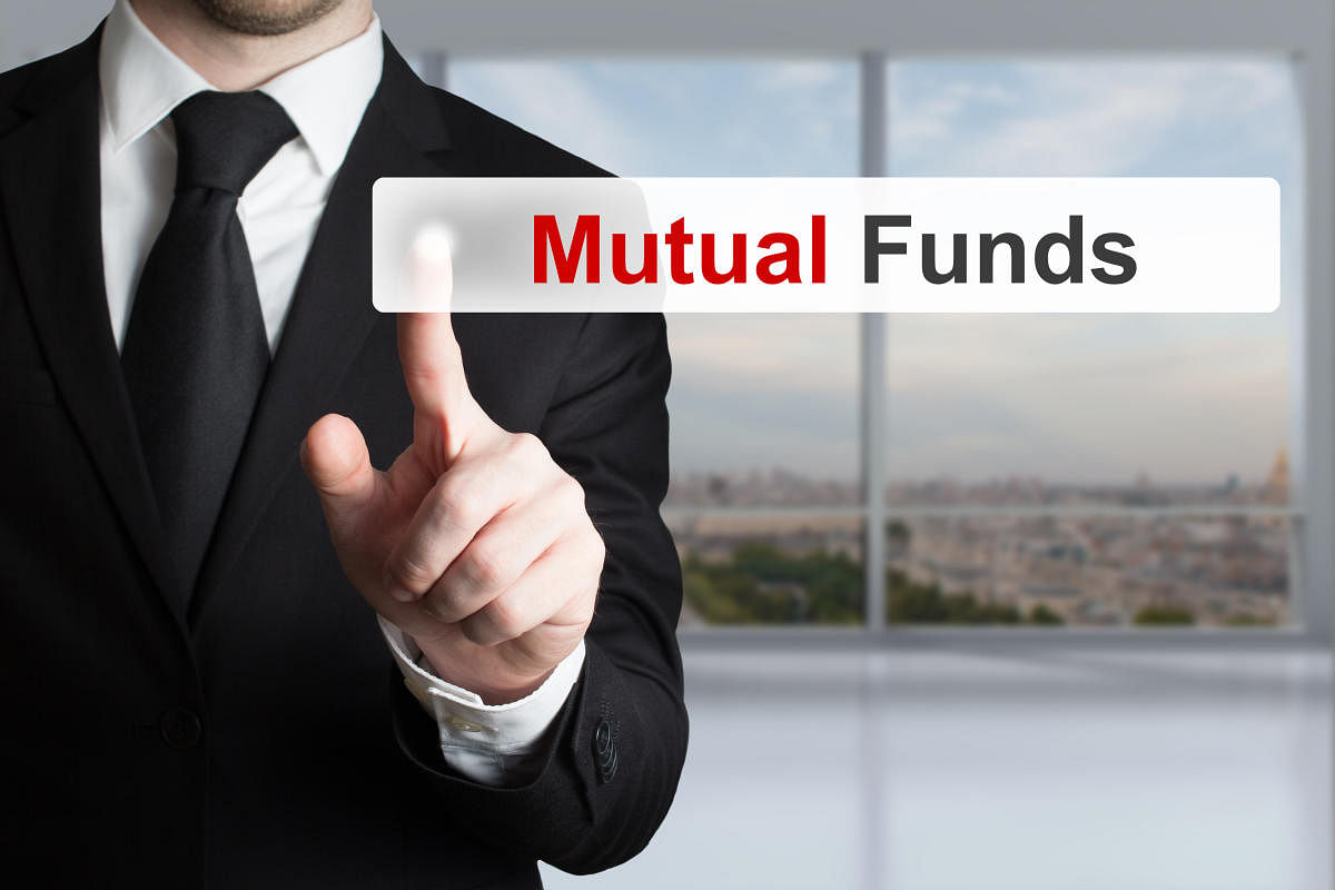 businessman in office pushing touchscreen button mutual fundsMutual Funds