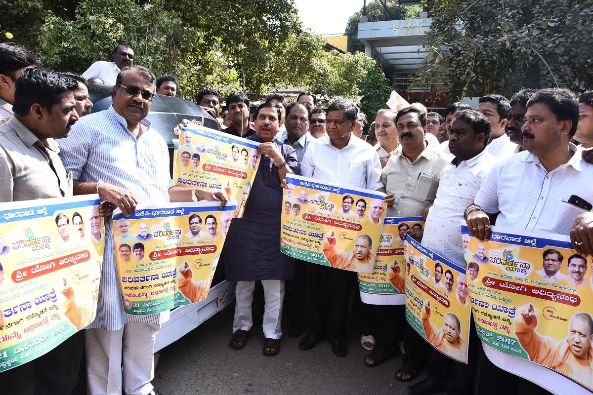 MP Pralhad Joshi, Leader of Opposition in Legislative Assembly Jagadish Shettar and others displaying Parivartana Yatra posters, during the launch of the Yatra publicity campaign, in Hubballi on Monday.