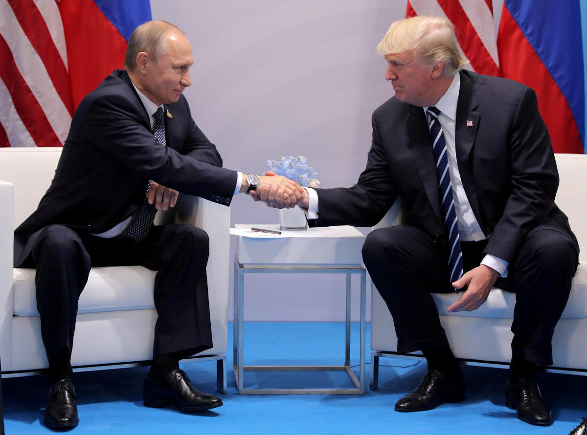 U.S. President Donald Trump shakes hands with Russia's President Vladimir Putin during their bilateral meeting at the G20 summit in Hamburg, Germany July 7, 2017. REUTERS/Carlos Barria/File Photo