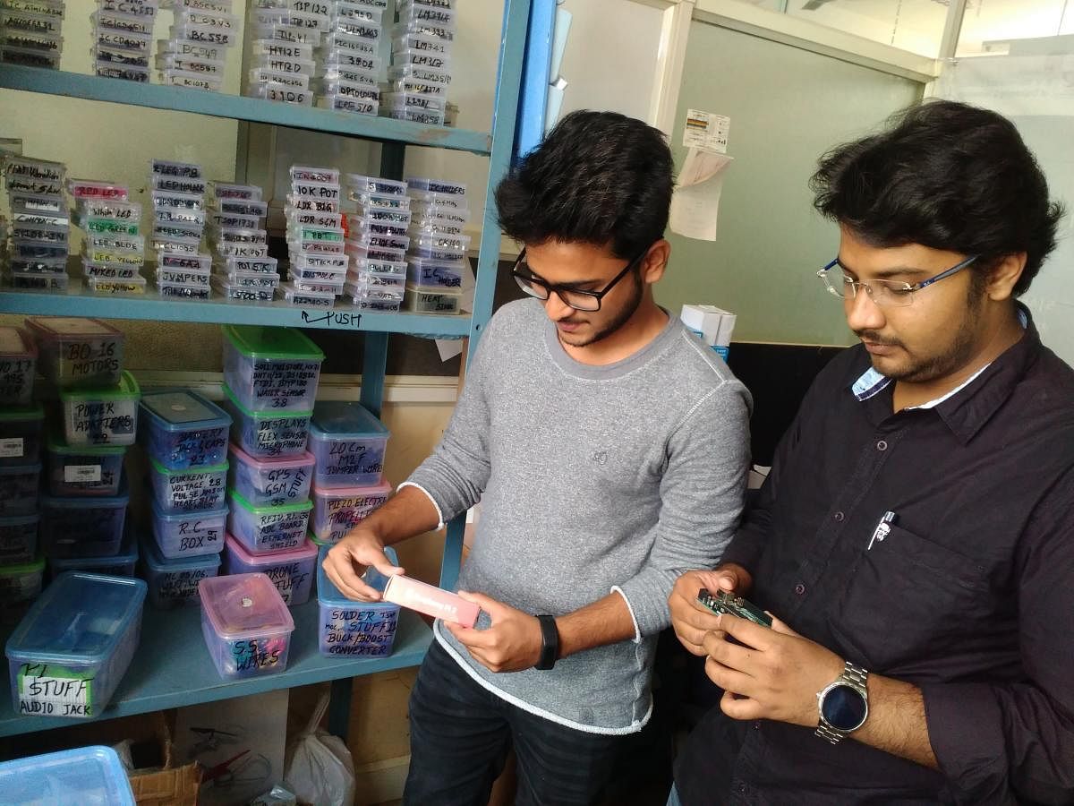 Adarsh and Samar checking electronics products kept for sale at 'Tweak Labs Inc' at KLETUCTIE in Hubballi.