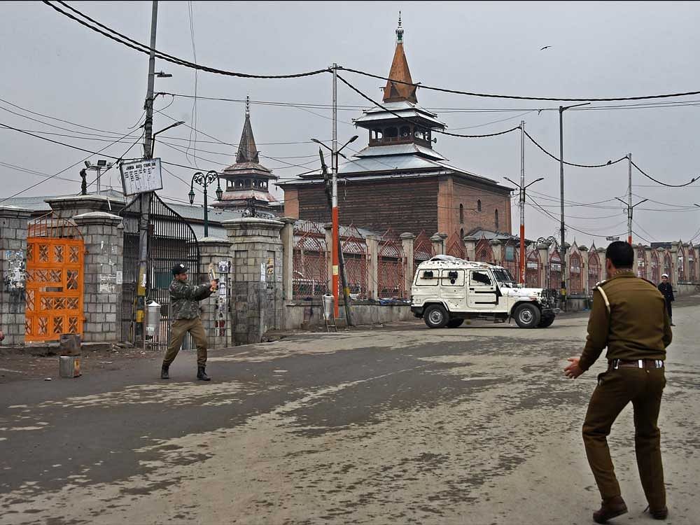 Policemen playing cricket outside Jamia Masjid during restrictions and strike in Srinagar on Wednesday. Authorities imposed restrictions in parts of Srinagar in view of the strike call given by separatists to protest against the killing of a civilian in the recent Shopian encounter. PTI Photo