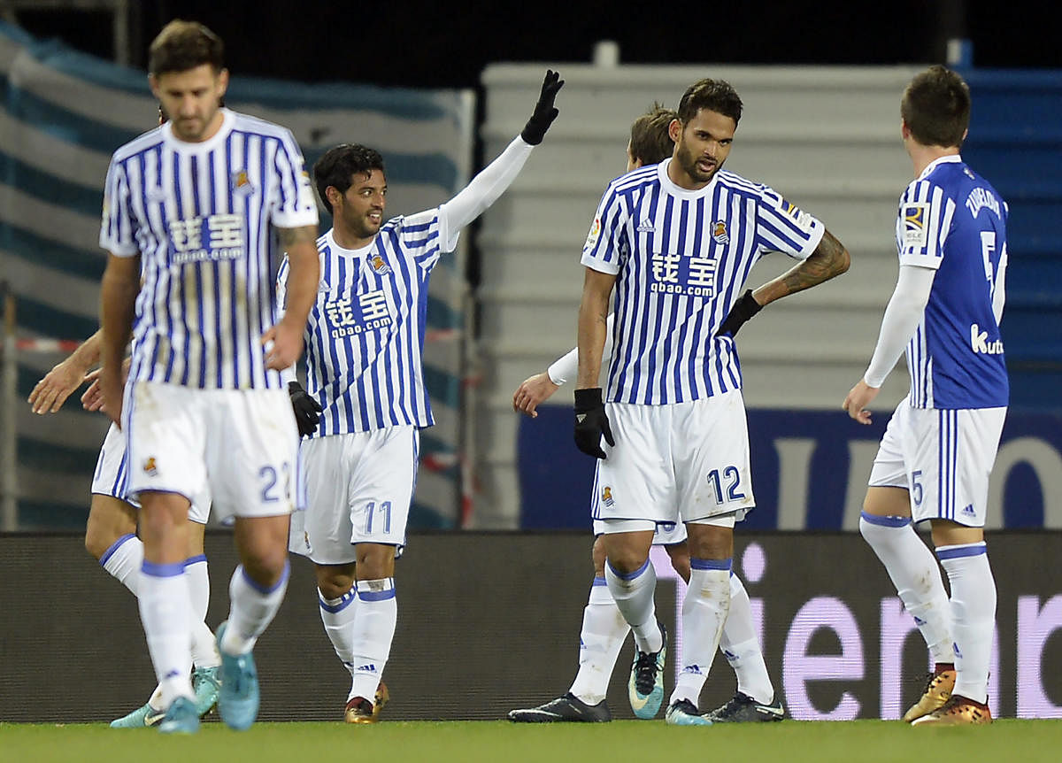 Real Sociedad's Carlos Vela (second from left) celebrates after scoring against Sevilla at the Anoeta stadium on Wednesday. AFP