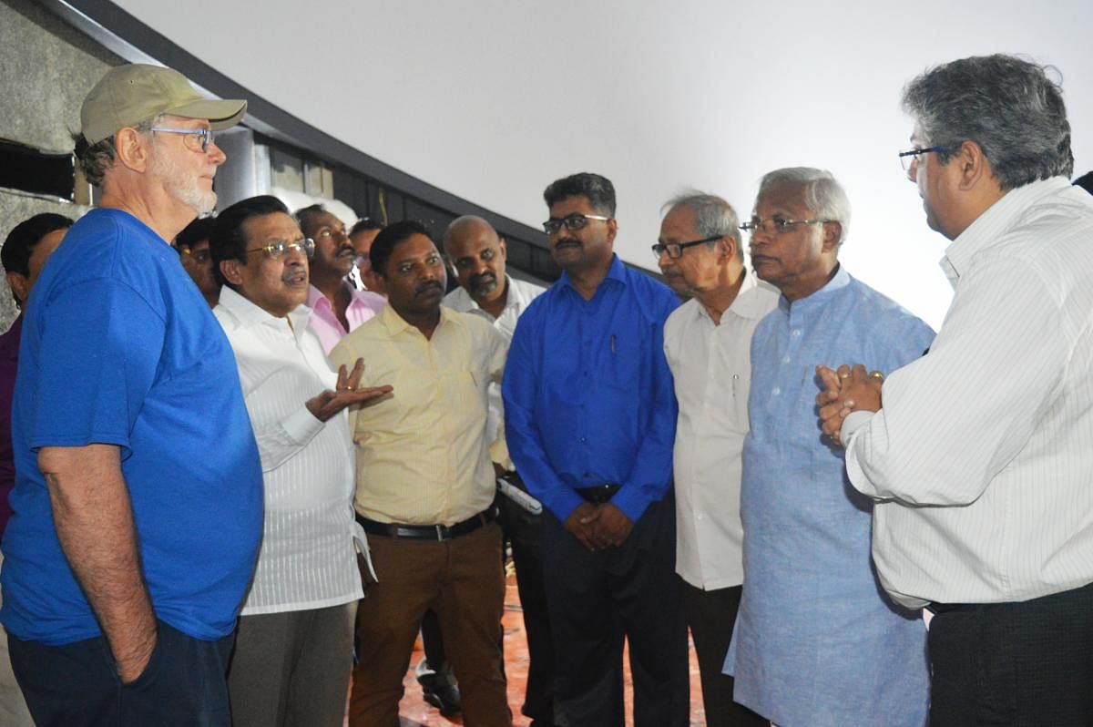 Planning and Statistics, Science and Technology Minister M R Seetharam discusses a point with experts during his review of progress on Swami Vivekananda Planetarium in Dr K Shivarama Karantha Pilikula Nisargadhama on Thursday.