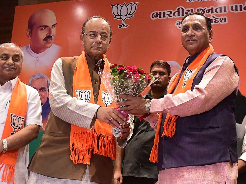 Finance Minister and BJP leader Arun Jaitley announces Vijay Rupani to continue as Chief Minister and Nitin Patel as Deputy CM of Gujarat at BJP party office in Gandhinagar, Ahmedabad on Friday. PTI Photo