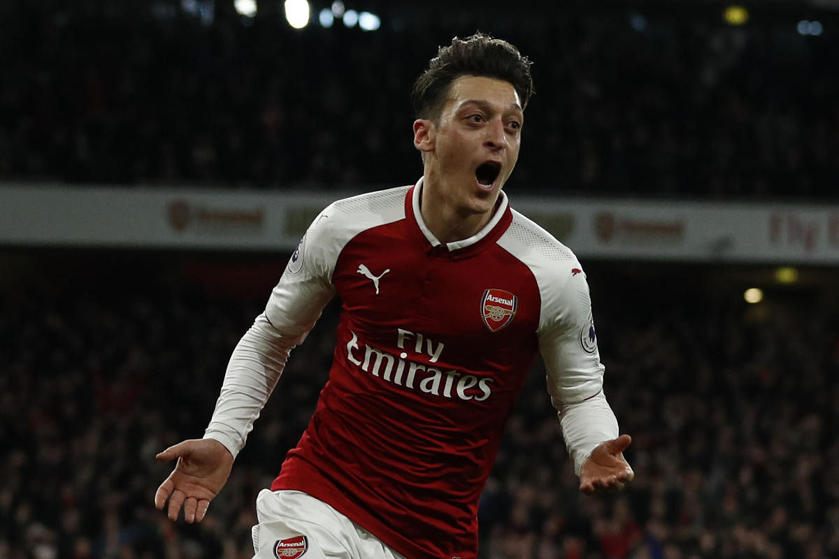 NAIL-BITER Arsenal's Mesut Ozil celebrates after scoring against Liverpool during their EPL clash on Friday night. AFP