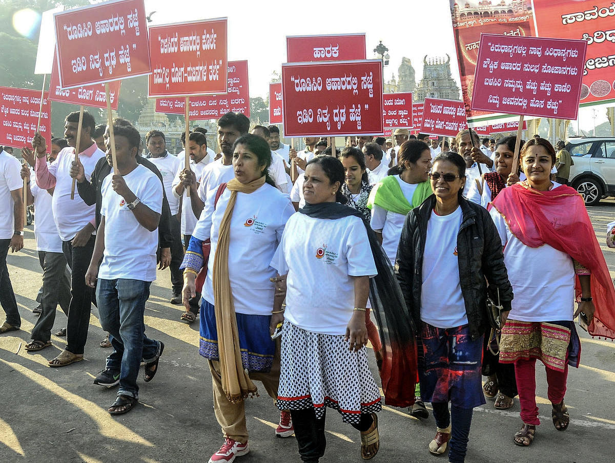 People take part in a walk to popularise millets ahead of Mysuru regional level organic and millets convention, from Kote Anjaneya Swami temple premises in Mysuru on Sunday December 24, 2017- PHOTO / DH PV PHOTOS