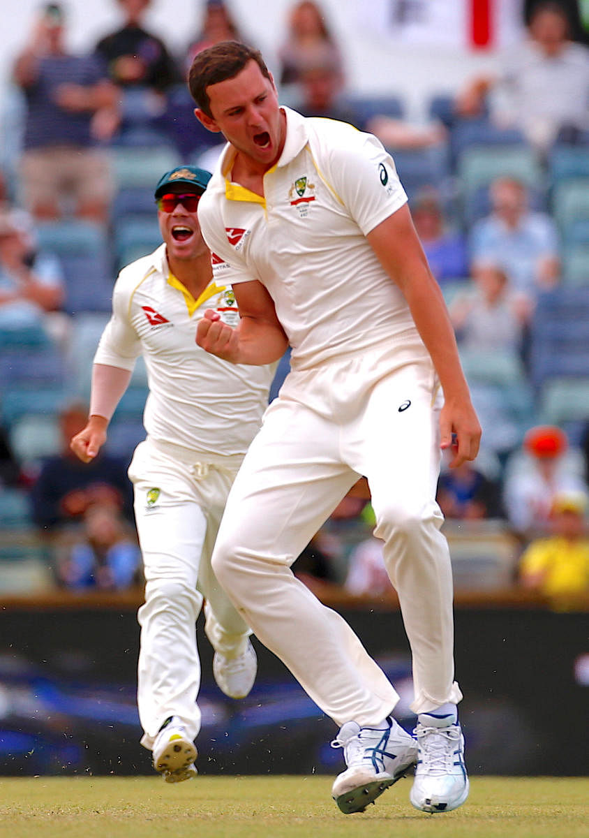 Cricket - Ashes test match - Australia v England - WACA Ground, Perth, Australia, December 18, 2017. Australia's Josh Hazlewood celebrates with team mate David Warner after bowling England's Jonny Bairstow during the fifth day of the third Ashes cricket test match. REUTERS/David Gray