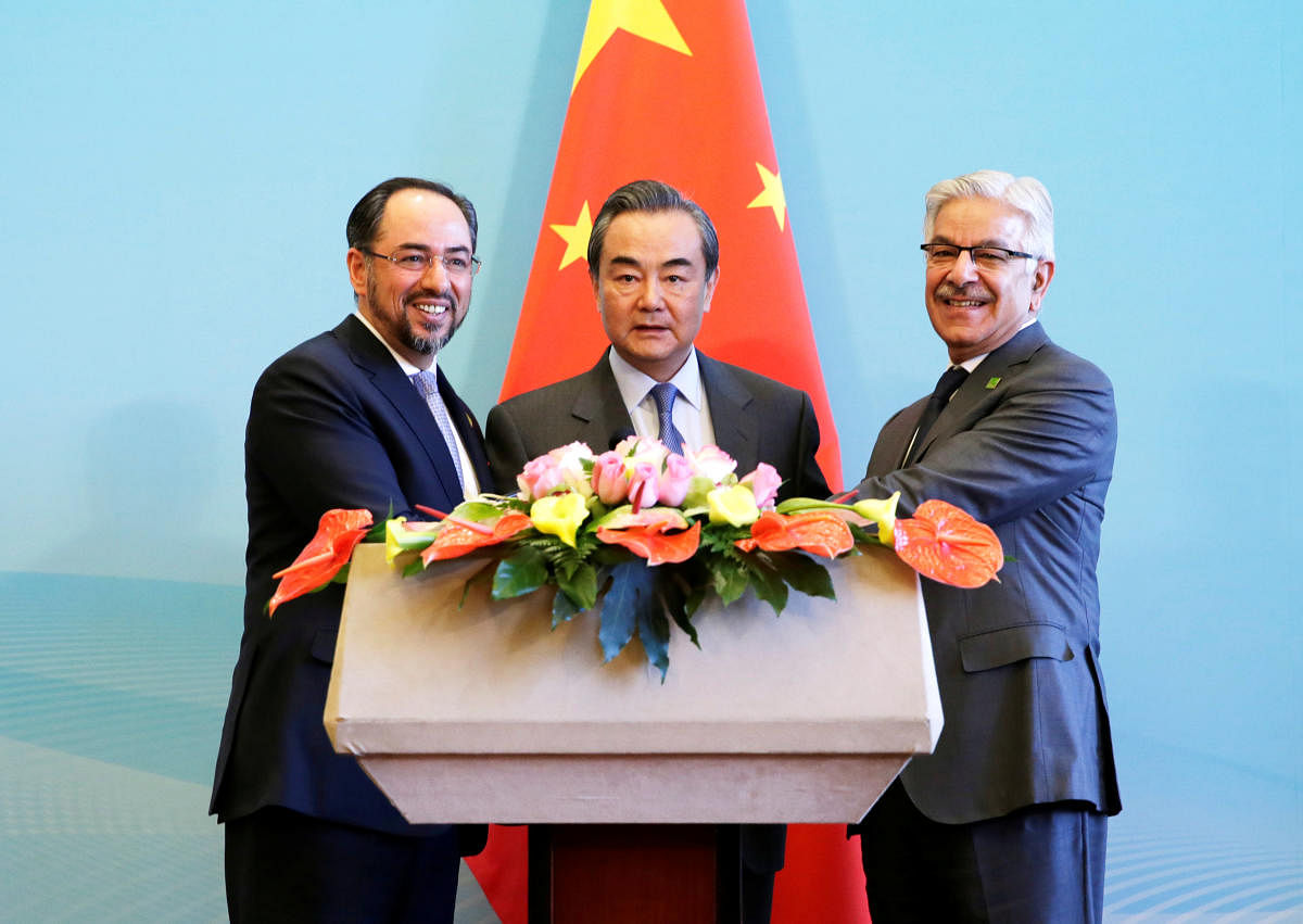 (From left) Afghan Foreign Minister Salahuddin Rabbani, Chinese Foreign Minister Wang Yi and Pakistani Foreign Minister Khawaja Asif attend a joint news conference in Beijing, China, on Tuesday. REUTERS