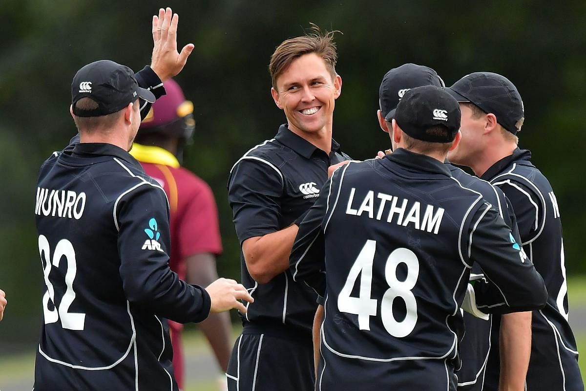 New Zealand's Trent Boult (centre) celebrates with team-mates after dismissing Chadwick Walton during the third ODI. AFP