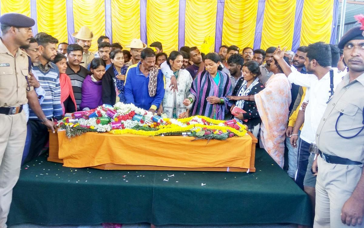 People pay homage to jawan Nagendra, who died of cardiac arrest, in Holenarasipur on Wednesday.