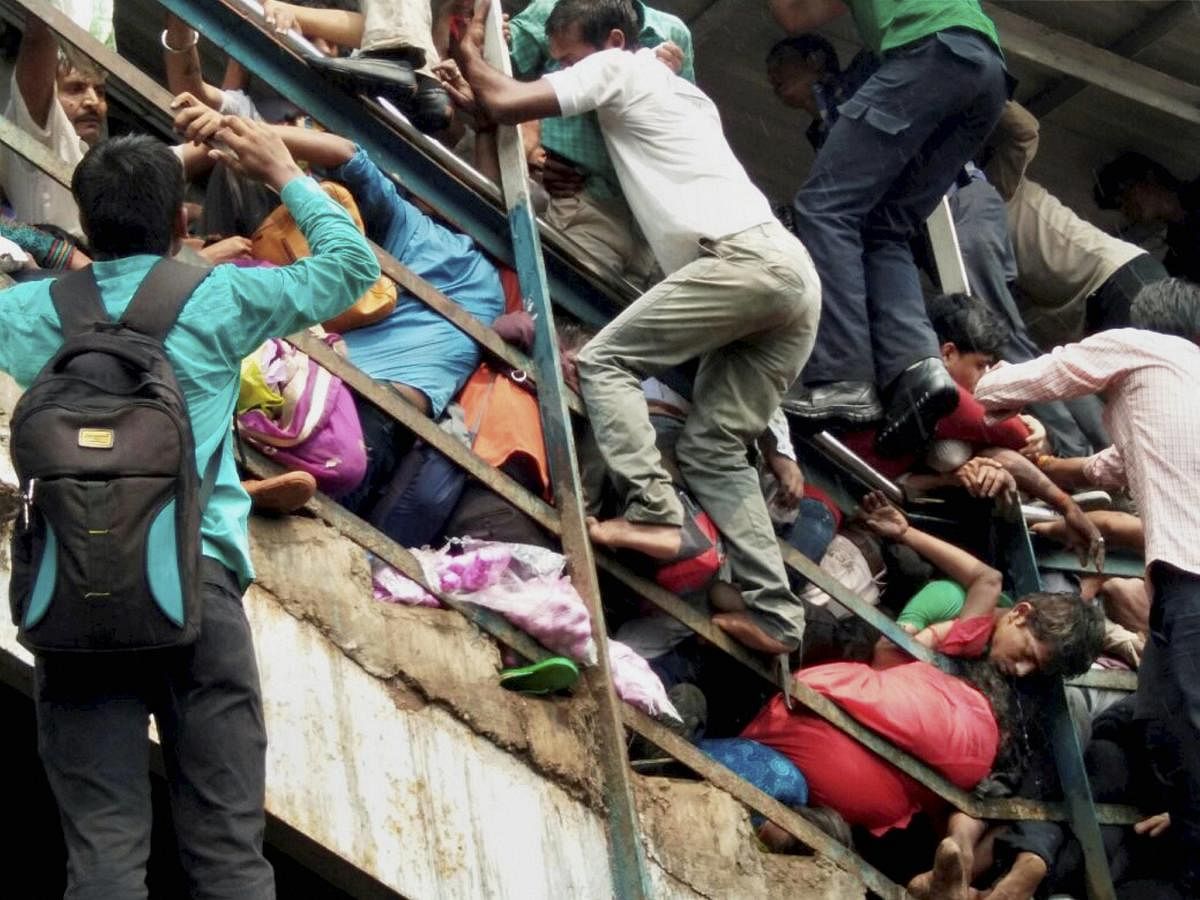 Passengers caught in a stampede at the Elphinstone railway station's foot overbridge in Mumbai. PTI FILE PHOTO