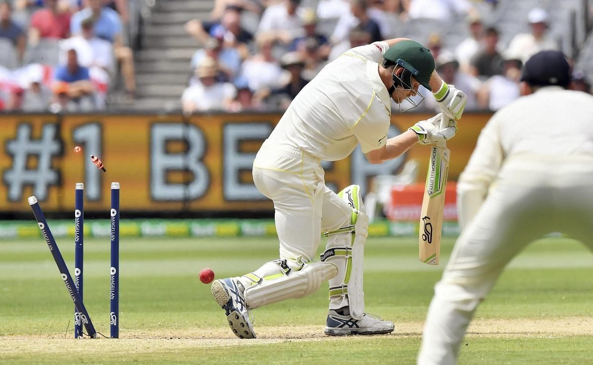 CHOPPED ON: Australia's Cameron Bancroft has his stumps uprooted by England's Chris Woakes at the MCG on Friday. AP/ PTI