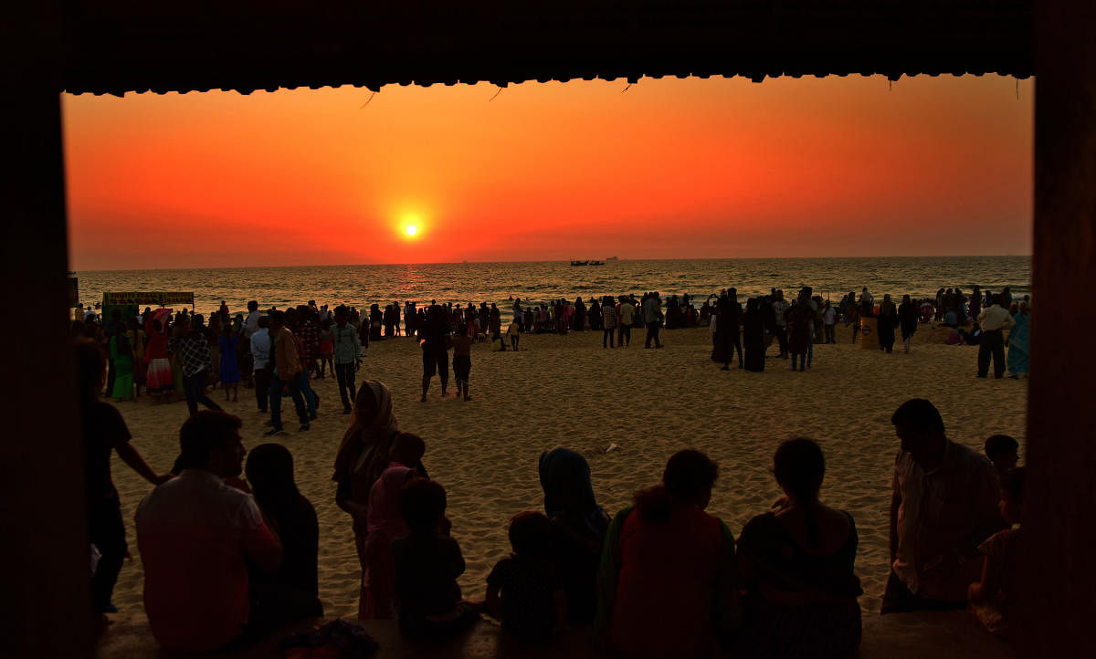 Visitors enjoy on the beach prior to the commencement of beach Utsav at Panambur beach on Friday evening.