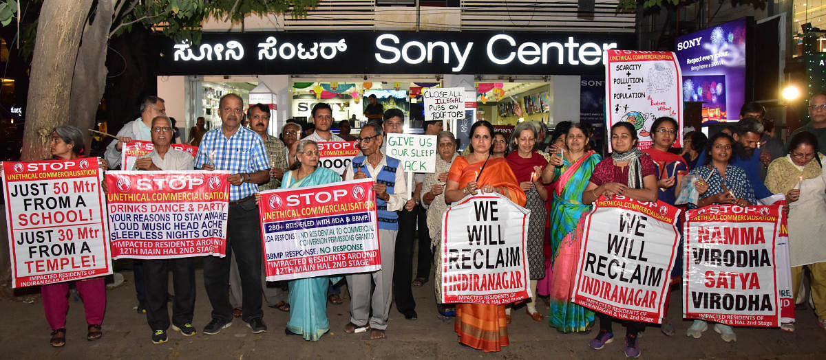 Residents of Indiranagara more than a100 people participated in the candle light vigil, against commercial establishments in by-lanes and nuisance created by Pubs n bars on 100 feet road and 12th main. ahead of the inspection by the joint commissioner of East, in Bengaluru on Friday. Photo/ B H Shivakumar