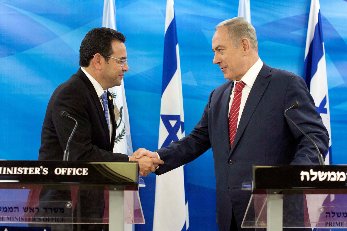 Guatemalan President Jimmy Morales (left) and Israeli Prime Minister Benjamin Netanyahu greet each other in Jerusalem. REUTERS
