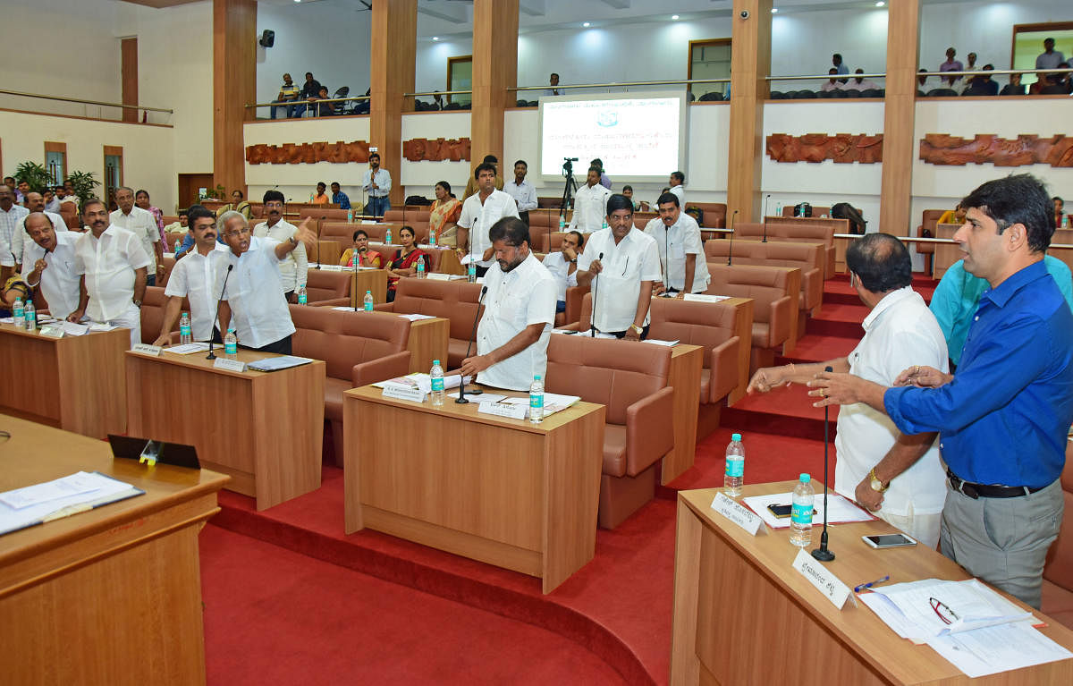 MLA J R Lobo exchanging words with the Opposition members of the Council during the meeting at the Mangaluru City Corporation on Saturday.