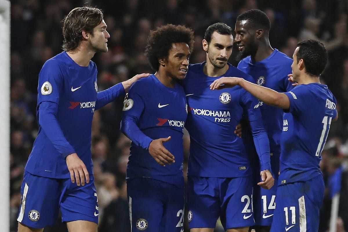 FIVE STAR Chelsea players celebrate a goal against Stoke City at Stamford Bridge on Saturday. AFP