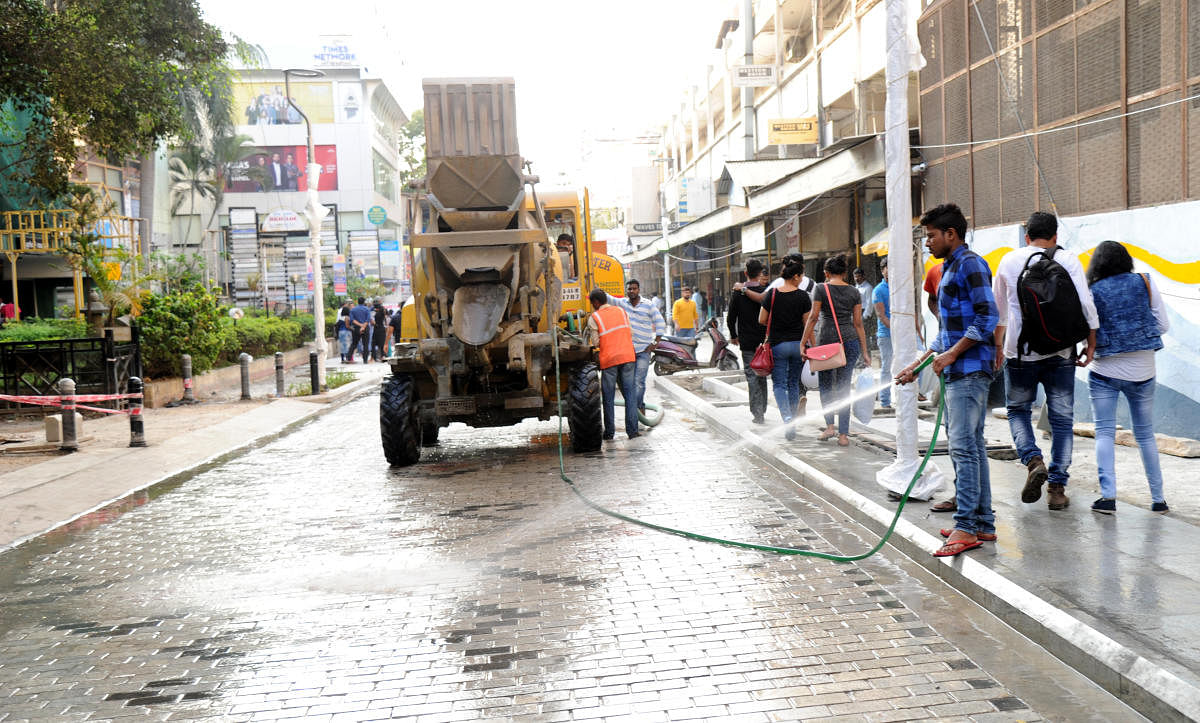 Worker cleaning church street on the eve of the 31st new tear celebration in Bengaluru on Saturday. Photo Srikanta Sharma R.