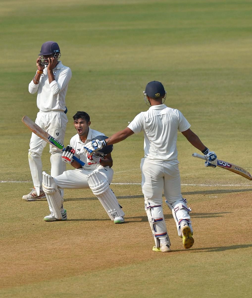 PUMPED UP Vidarbha's Akshay Wadkar (centre) celebrates his century on the third day of the Ranji Trophy final against Delhi in Indore on Sunday. PTI