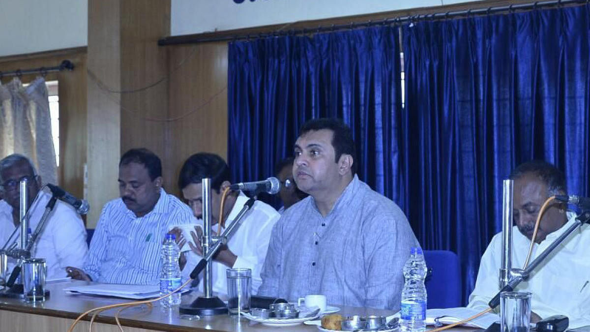 District in-charge minister Pramod Madhwaraj speaks at a meeting in Udupi.