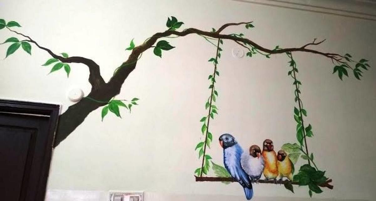 Artists paint lively images on the walls of the Old age home
