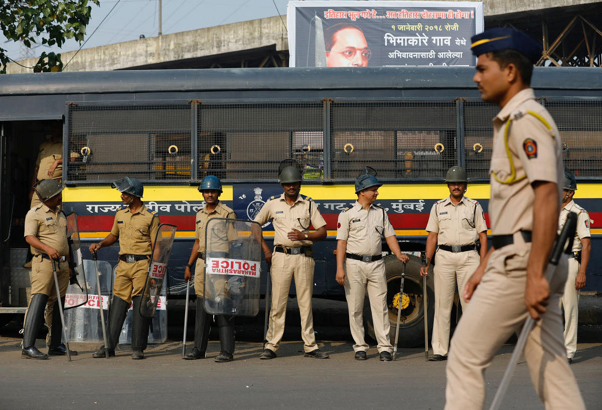 Policemen stand guard at a traffic junction in Mumbai on Wednesday. REUTERS