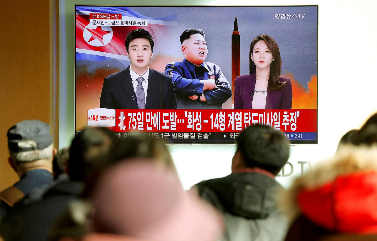 People watch a TV broadcasting a news report on North Korea firing an intercontinental ballistic missile (ICBM) that landed close to Japan, in Seoul, South Korea. REUTERS FILE PHOTO
