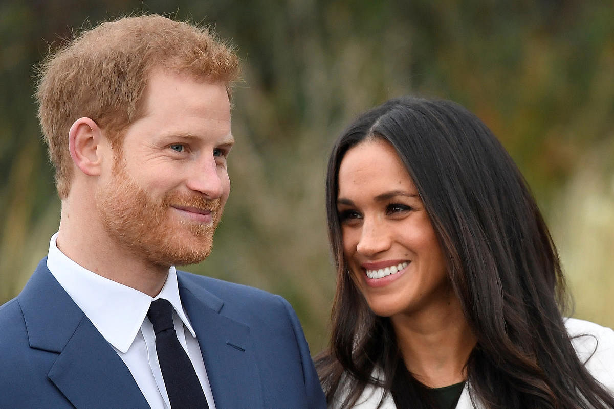 Britain's Prince Harry poses with Meghan Markle in the Sunken Garden of Kensington Palace in London. Reuters file photo