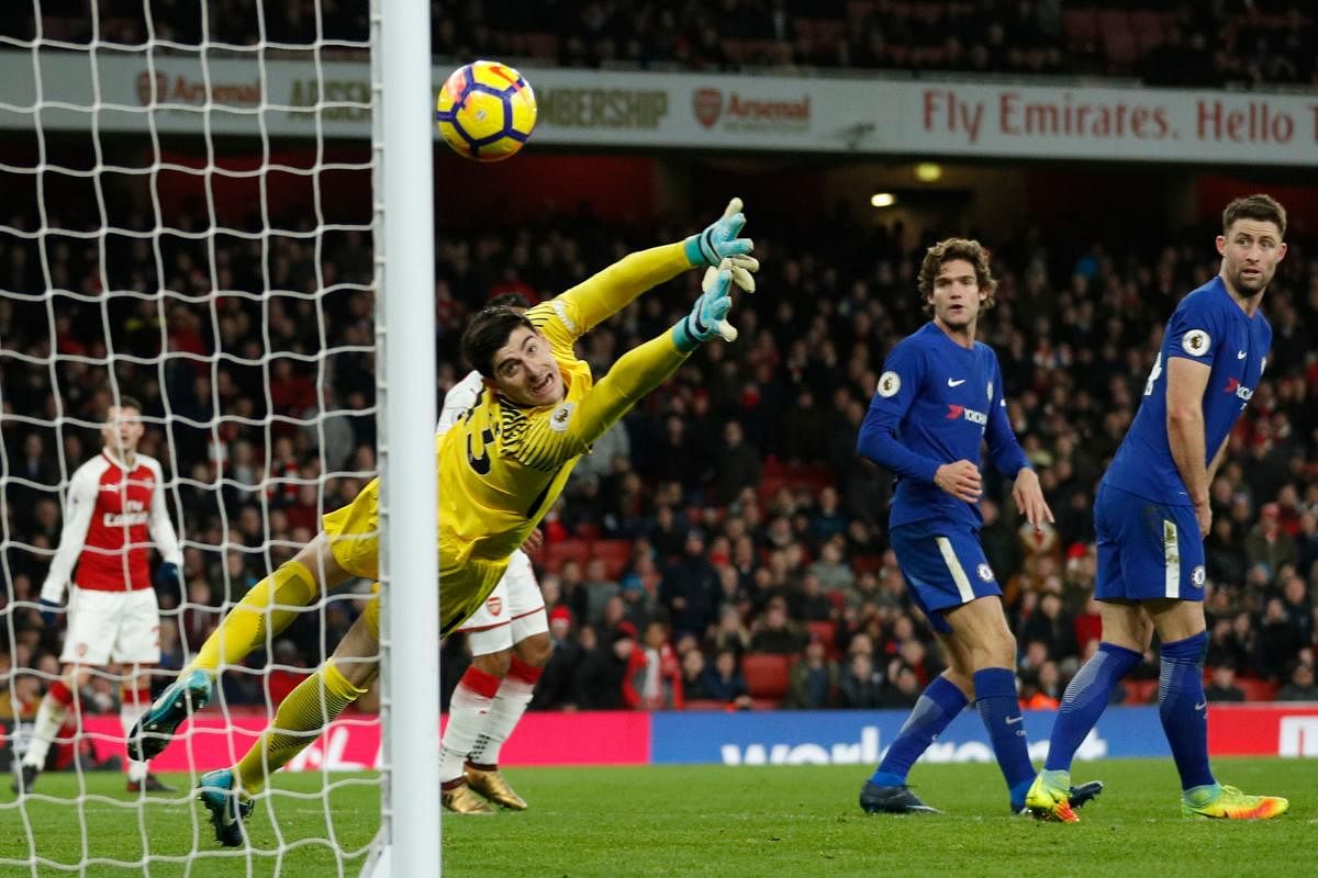 Chelsea goalkeeper Thibaut Courtois watches Hector Bellerin's (Arsenal) shot soar into the net during their entertaining derby on Wednesday. AFP