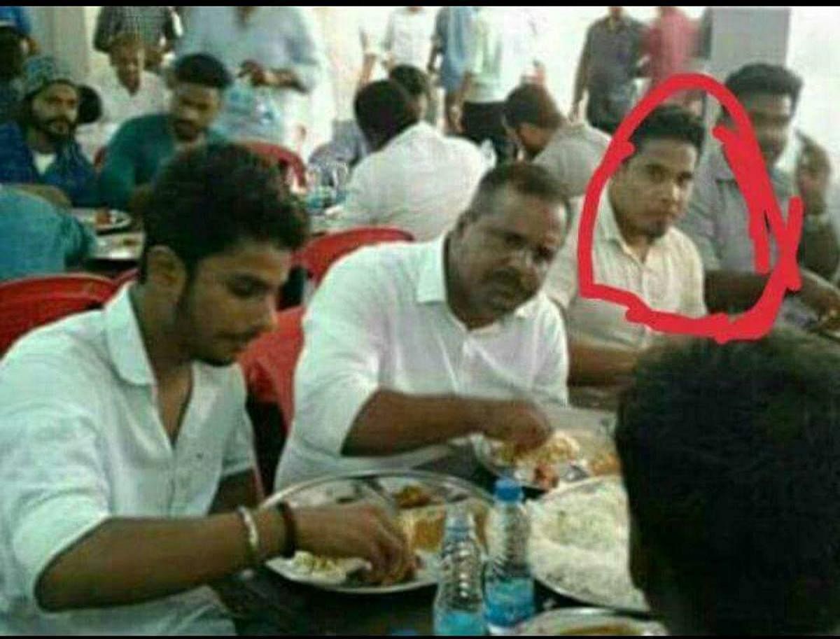 Food and Civil Supplies Minister U T Khader having food in a programme in which a Target group member Ilyas is also seen having food.