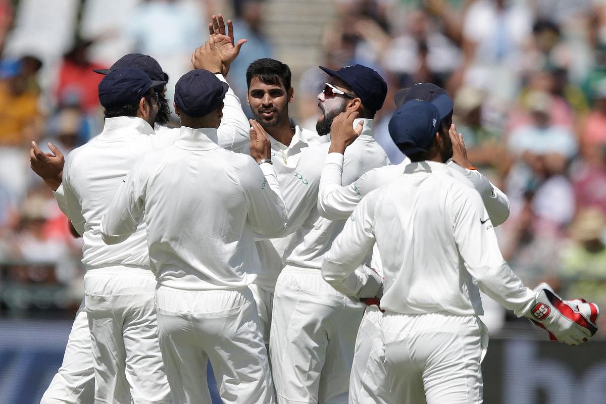 WRECKER IN CHIEF India's Bhuvneshwar Kumar (centre) celebrates with team-mates the dismissal of South Africa's Dean Elgar on the opening day of the first Test. AFP