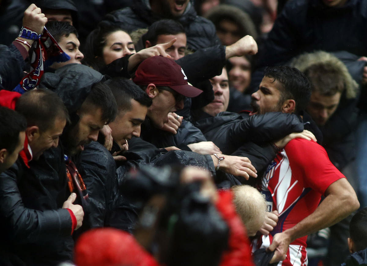 I'M BACK Atletico Madrid striker Diego Costa celebrates with fans after scoring. Costa, who had been booked earlier, was sent-off for his celebration. AFP