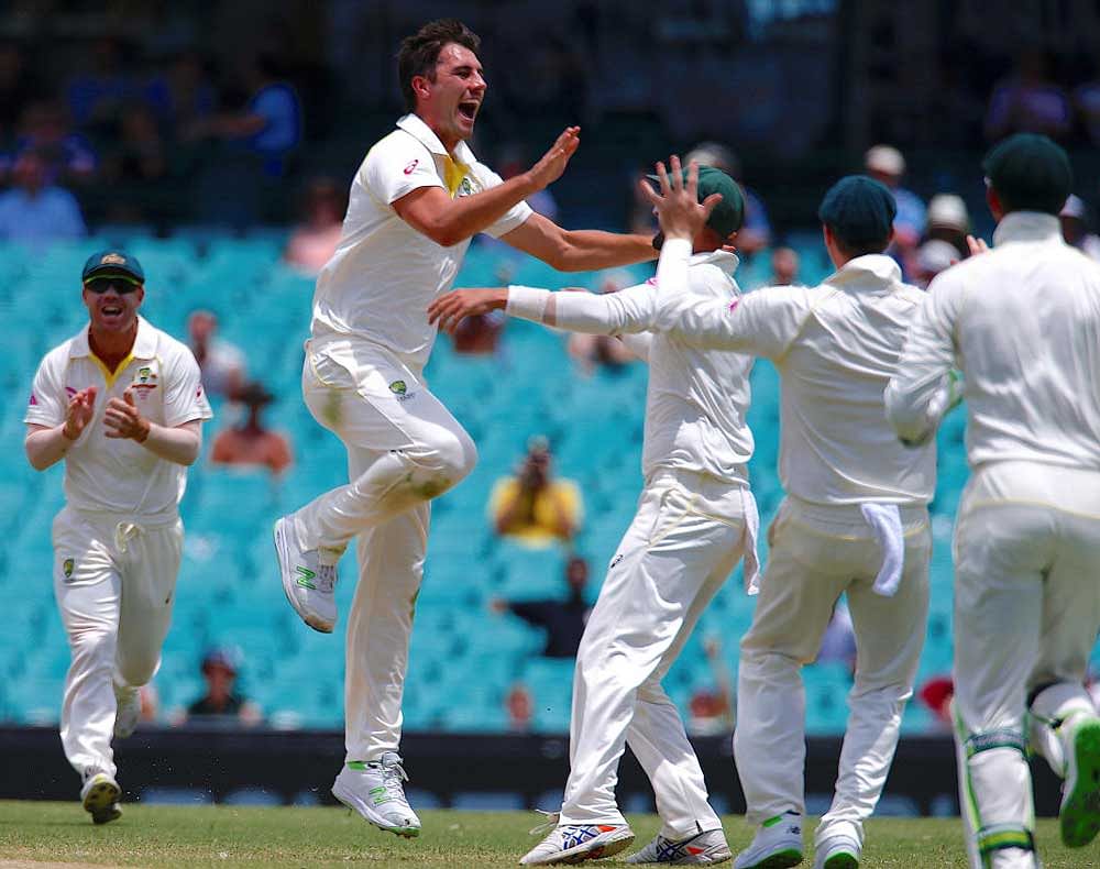 Australia's Pat Cummins celebrates with team mates after dismissing England's Jonny Bairstow during the fifth day of the fifth Ashes cricket test match. REUTERS