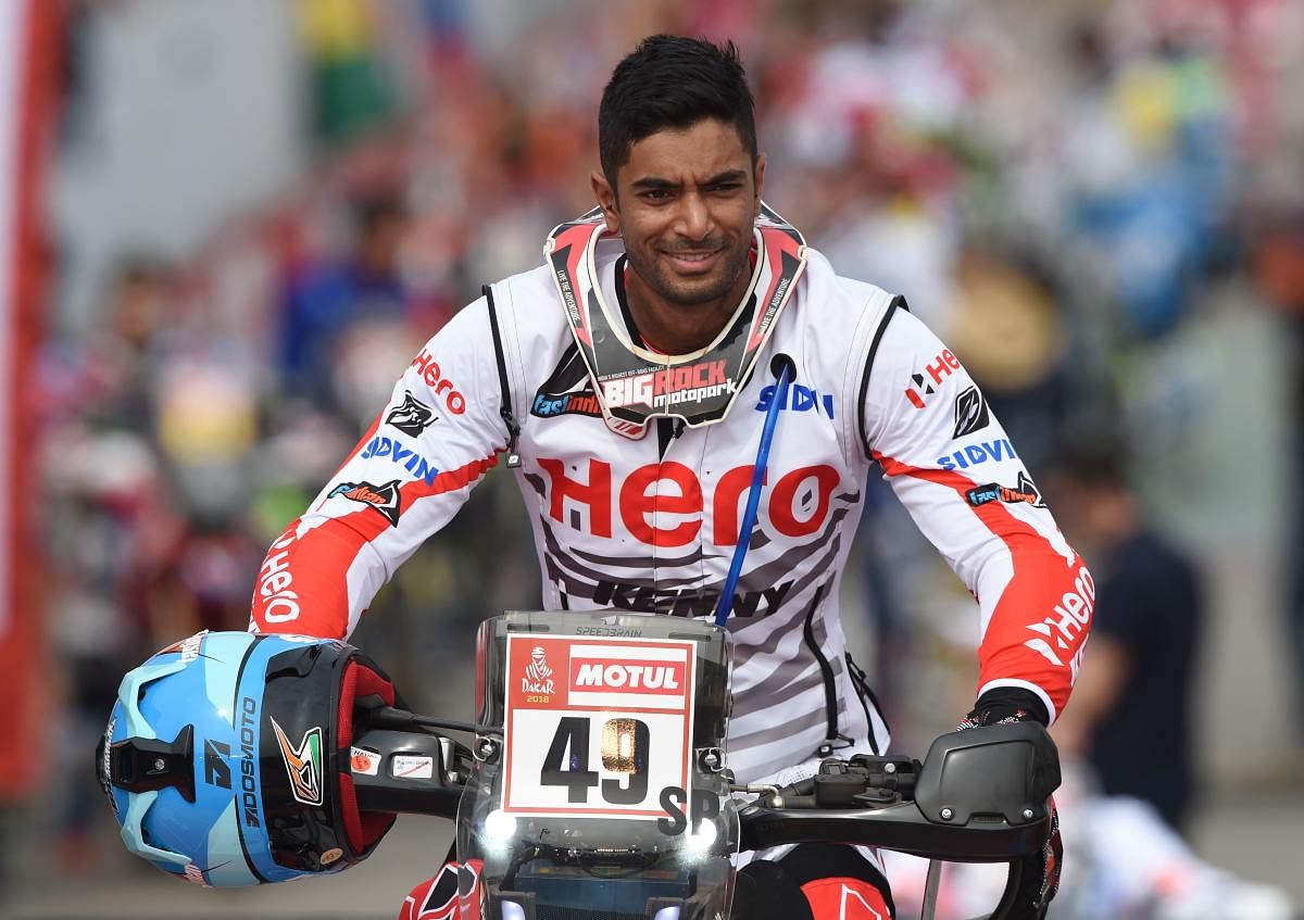 Hero Motosports Team Rally's Indian biker Santosh Chunchunguppe Shivashankar, is pictured on the podium during the start of the 2018 Dakar Rally, ahead of the rally's Lima-Pisco Stage 1, in Lima on January 6, 2018. The 40th edition of the Dakar Rally will take competitors through Peru, Bolivia and Argentina until January 20. / AFP PHOTO / Cris BOURONCLE