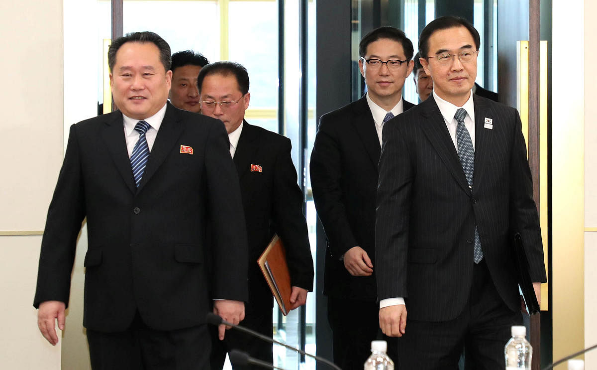 Head of the North Korean delegation Ri Son Gwon and his South Korean counterpart Cho Myoung-gyon arrive for their meeting at the truce village of Panmunjom in the demilitarised zone separating the two Koreas, South Korea, January 9, 2018. REUTERS