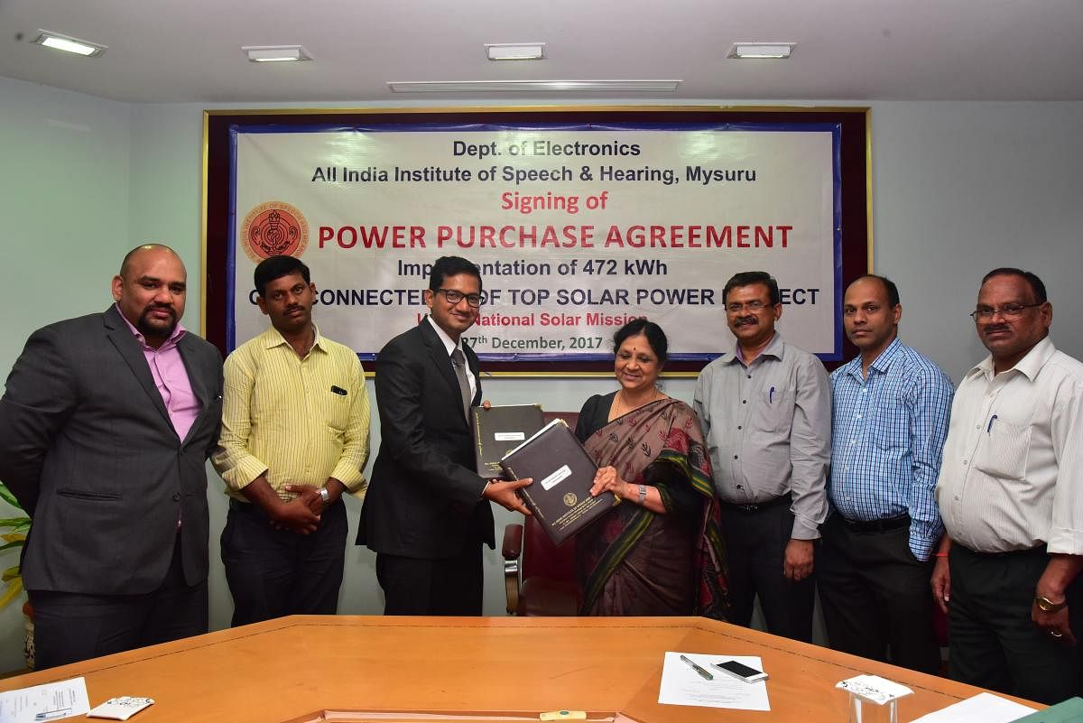 S R Savithri, Director of AIISH, exchanges the PPA with Vikram Reddy, general manager (south India) of Sun Renewables, Gurgaon, and Shivananda, project head, in Mysuru, recently. Ajish K Abraham, S Ramkumar, and K Purushotham are seen.