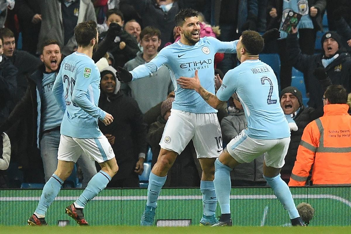 ON TARGET Manchester City's Sergio Aguero (centre) celebrates with teammates after scoring winner on Tuesday. AFP